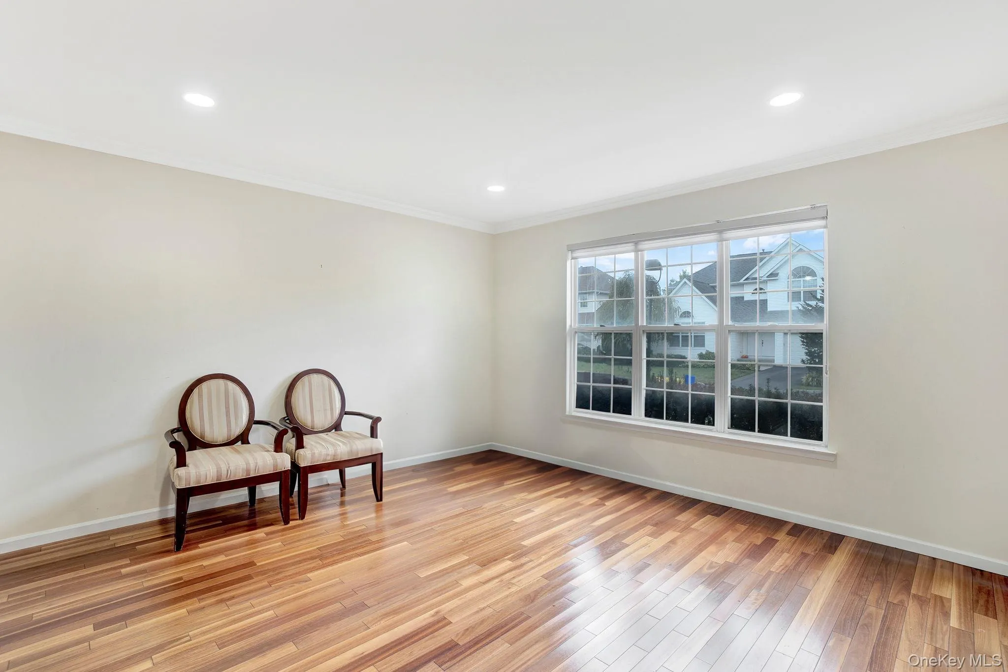 Unfurnished room featuring ornamental molding, light wood-style floors, and recessed lighting Unfurnished room featuring ornamental molding, light wood-style floors, and recessed lighting