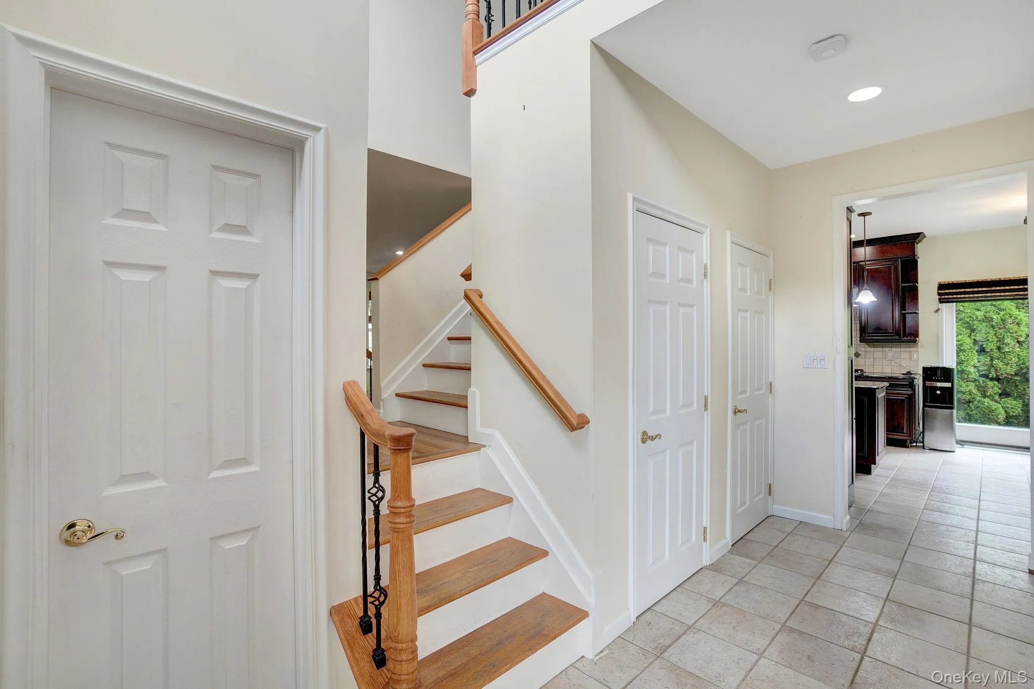 Staircase featuring tile patterned floors and baseboards Staircase featuring tile patterned floors and baseboards