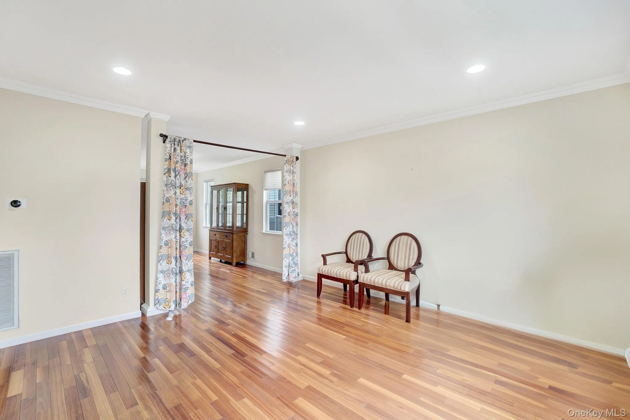 Unfurnished room featuring light wood-style flooring, ornamental molding, and recessed lighting Unfurnished room featuring light wood-style flooring, ornamental molding, and recessed lighting