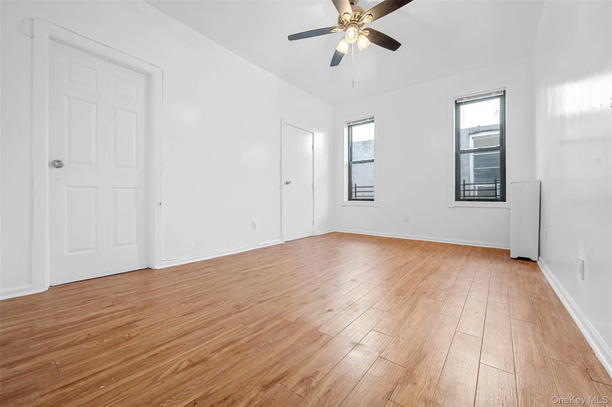 Unfurnished bedroom featuring light wood-style flooring and a ceiling fan Unfurnished bedroom featuring light wood-style flooring and a ceiling fan