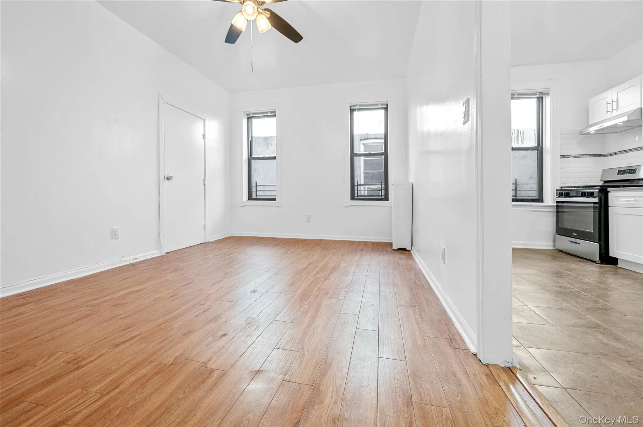 Unfurnished living room featuring healthy amount of natural light, light wood-style floors, and ceiling fan Unfurnished living room featuring healthy amount of natural light, light wood-style floors, and ceiling fan