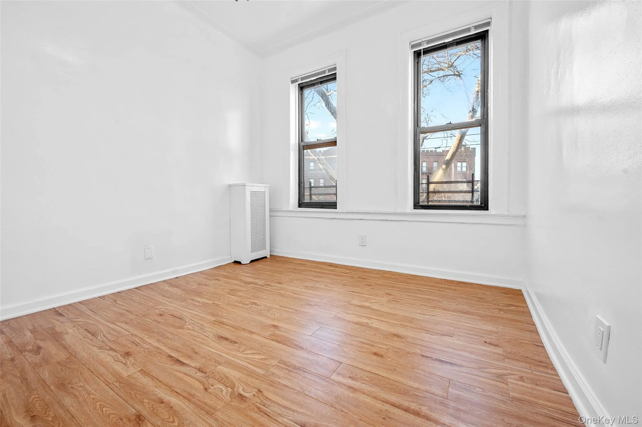 Spare room featuring light wood-style flooring and vaulted ceiling Spare room featuring light wood-style flooring and vaulted ceiling