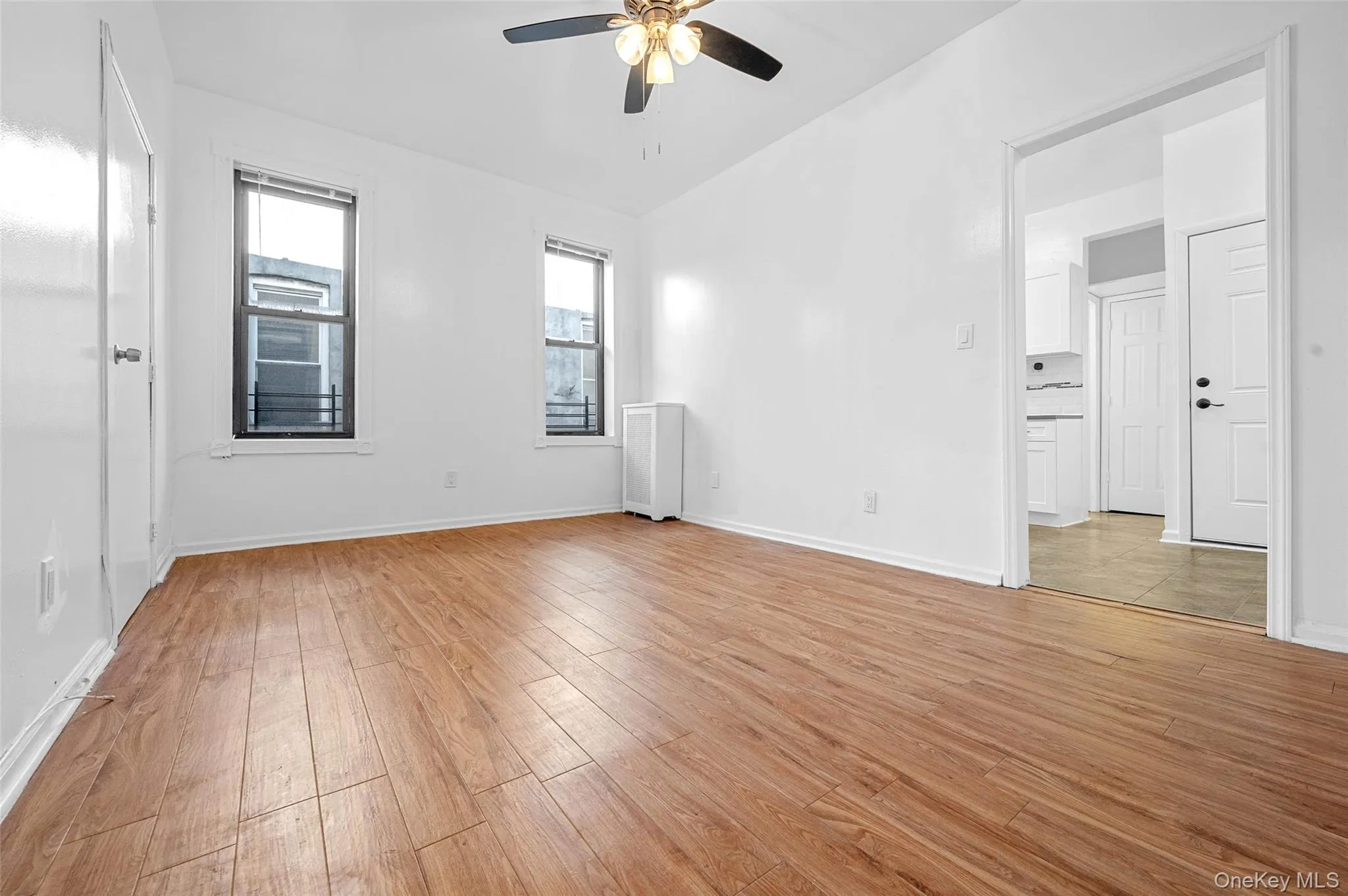 Empty room featuring light wood-type flooring and a ceiling fan Empty room featuring light wood-type flooring and a ceiling fan