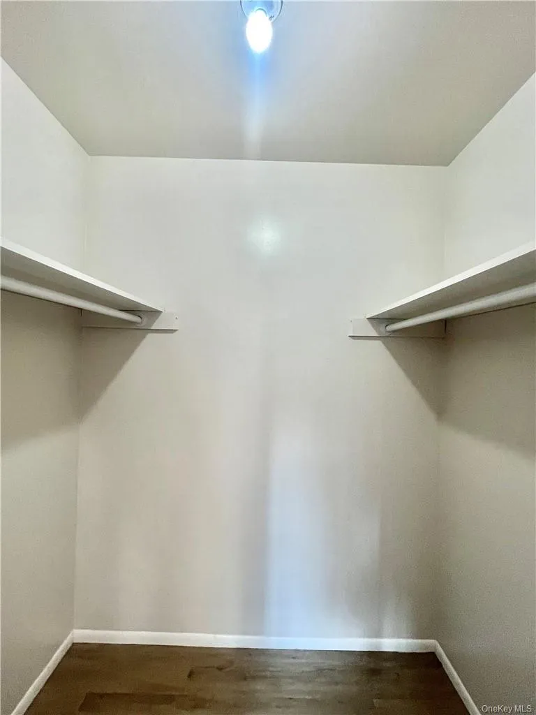 Spacious closet with hardwood / wood-style floors Spacious closet with hardwood / wood-style floors