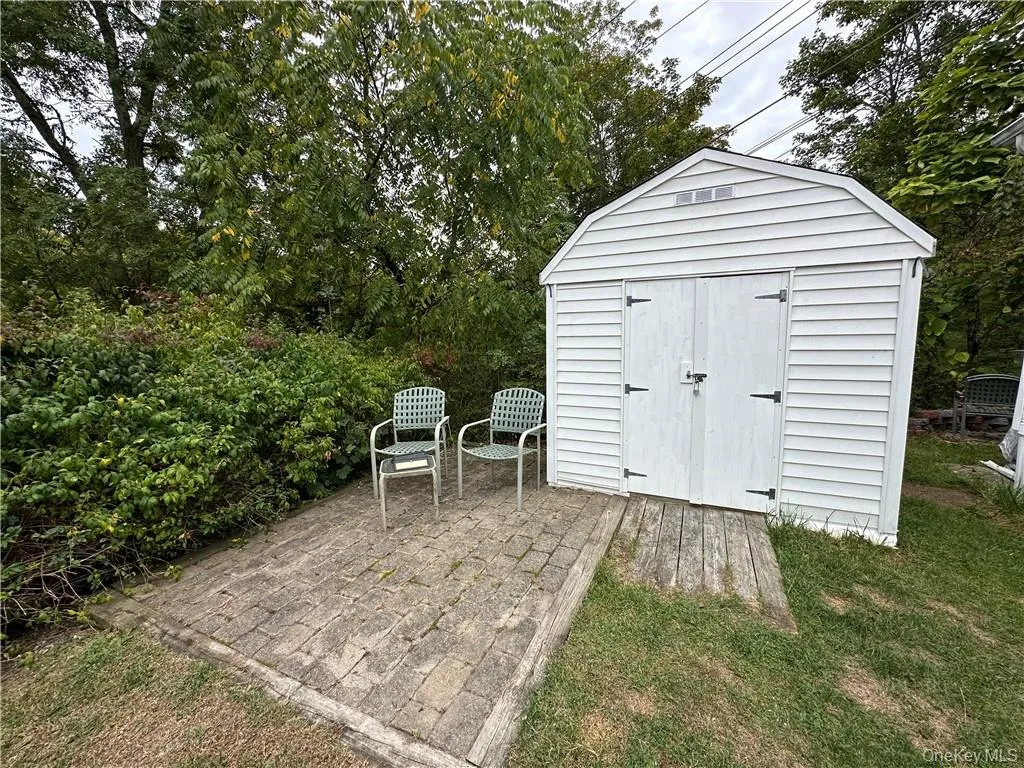 View of outbuilding featuring a yard View of outbuilding featuring a yard