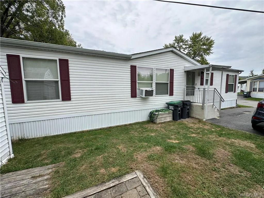 View of front of home featuring cooling unit and a front lawn View of front of home featuring cooling unit and a front lawn