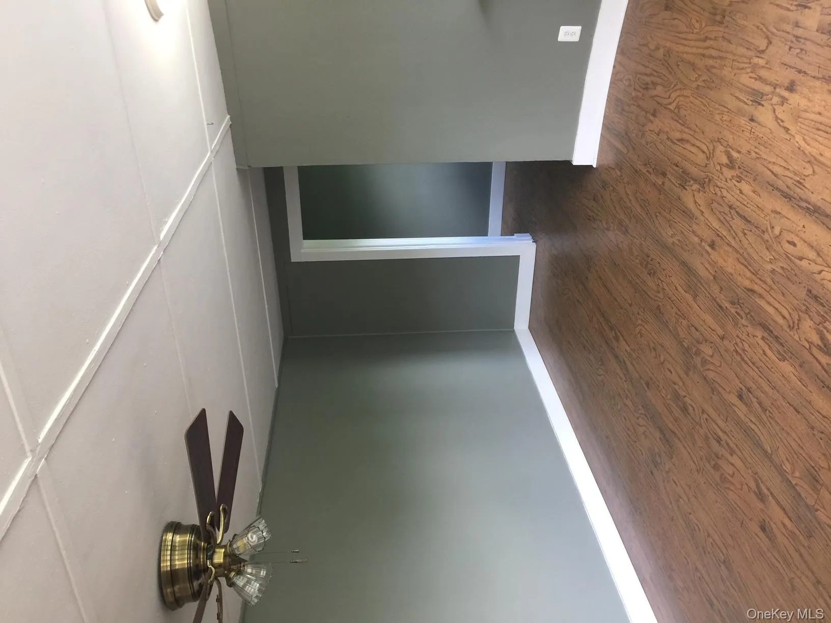 Spare room with dark wood-type flooring and a ceiling fan Spare room with dark wood-type flooring and a ceiling fan