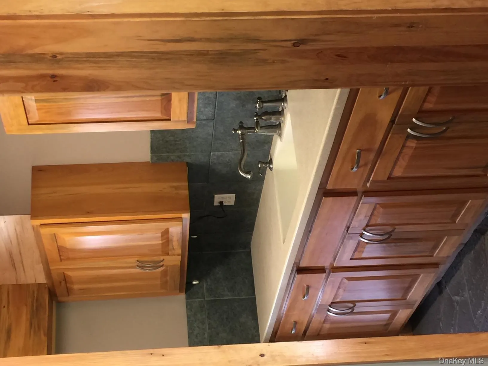 Kitchen with backsplash, light countertops, and brown cabinetry Kitchen with backsplash, light countertops, and brown cabinetry