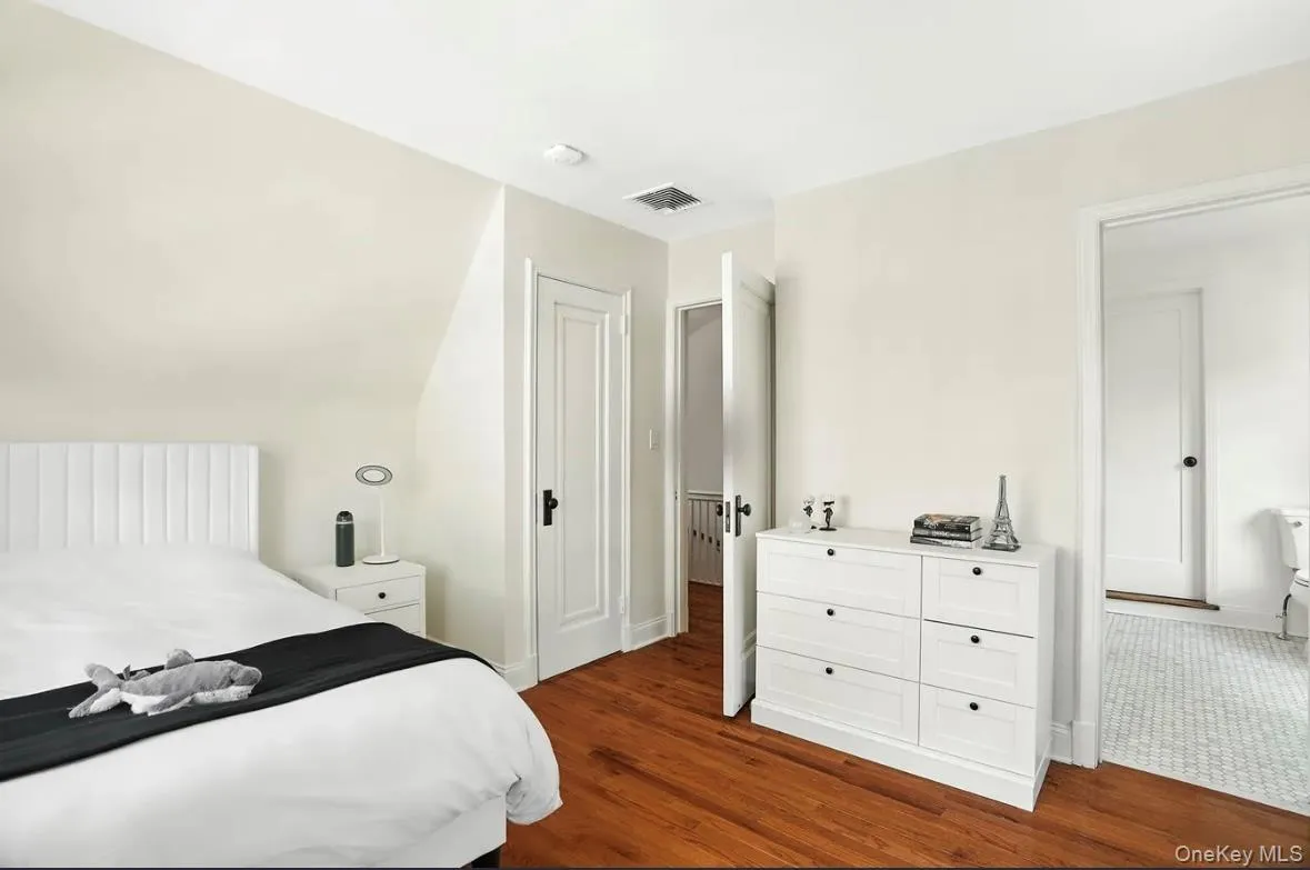Bedroom featuring dark wood-style floors and baseboards Bedroom featuring dark wood-style floors and baseboards