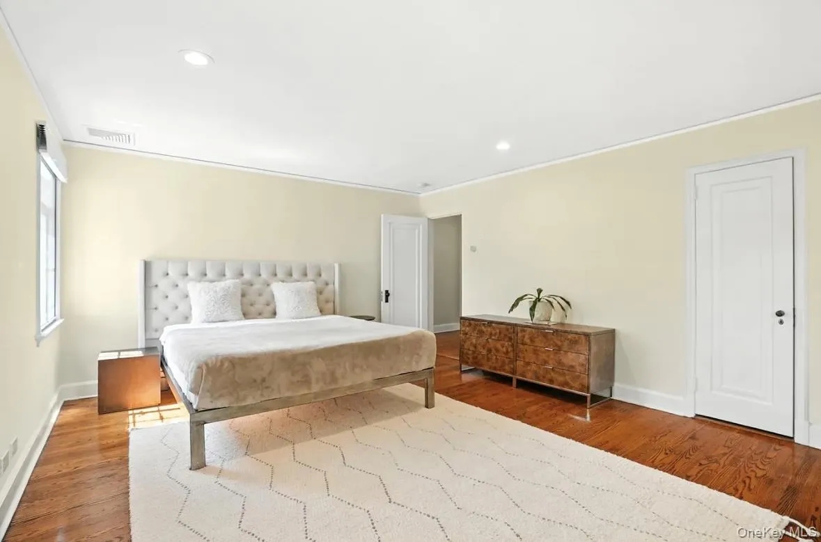 Bedroom with recessed lighting, wood finished floors, and crown molding Bedroom with recessed lighting, wood finished floors, and crown molding