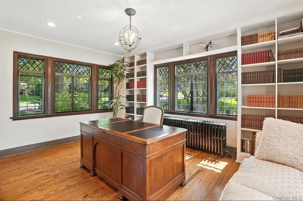Office space with radiator, light wood-type flooring, recessed lighting, a chandelier, and ornamental molding Office space with radiator, light wood-type flooring, recessed lighting, a chandelier, and ornamental molding