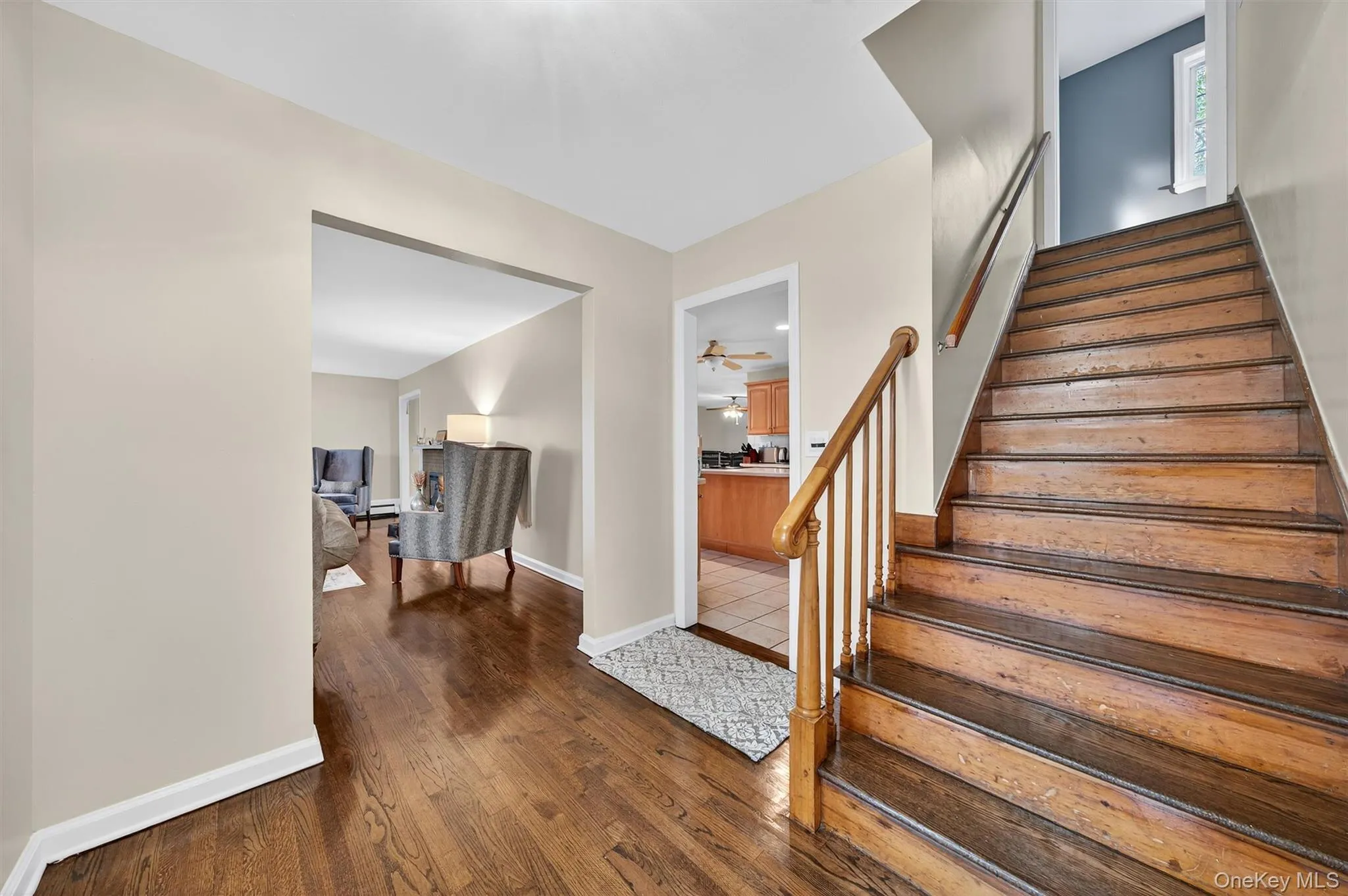 Stairs featuring wood finished floors and baseboards Stairs featuring wood finished floors and baseboards