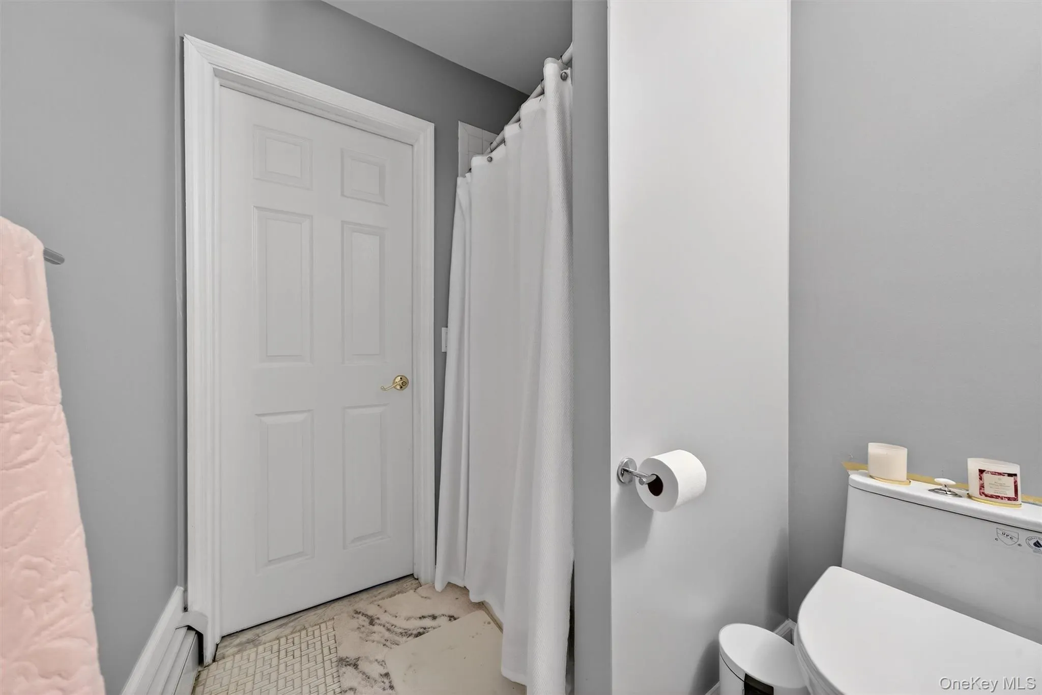 Bathroom with curtained shower and toilet Bathroom with curtained shower and toilet