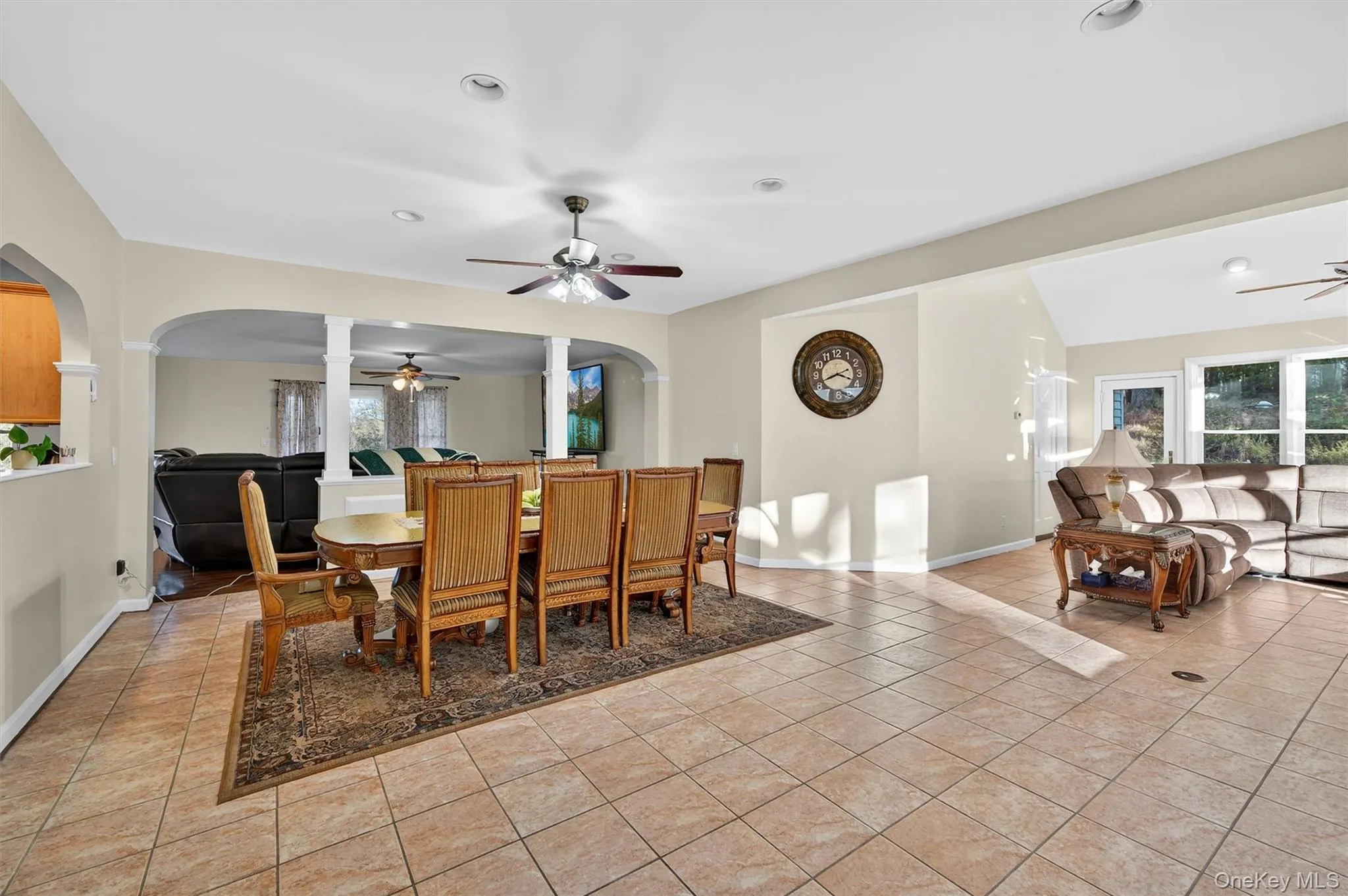 Dining space featuring arched walkways, ceiling fan, light tile patterned floors, healthy amount of natural light, and recessed lighting Dining space featuring arched walkways, ceiling fan, light tile patterned floors, healthy amount of natural light, and recessed lighting
