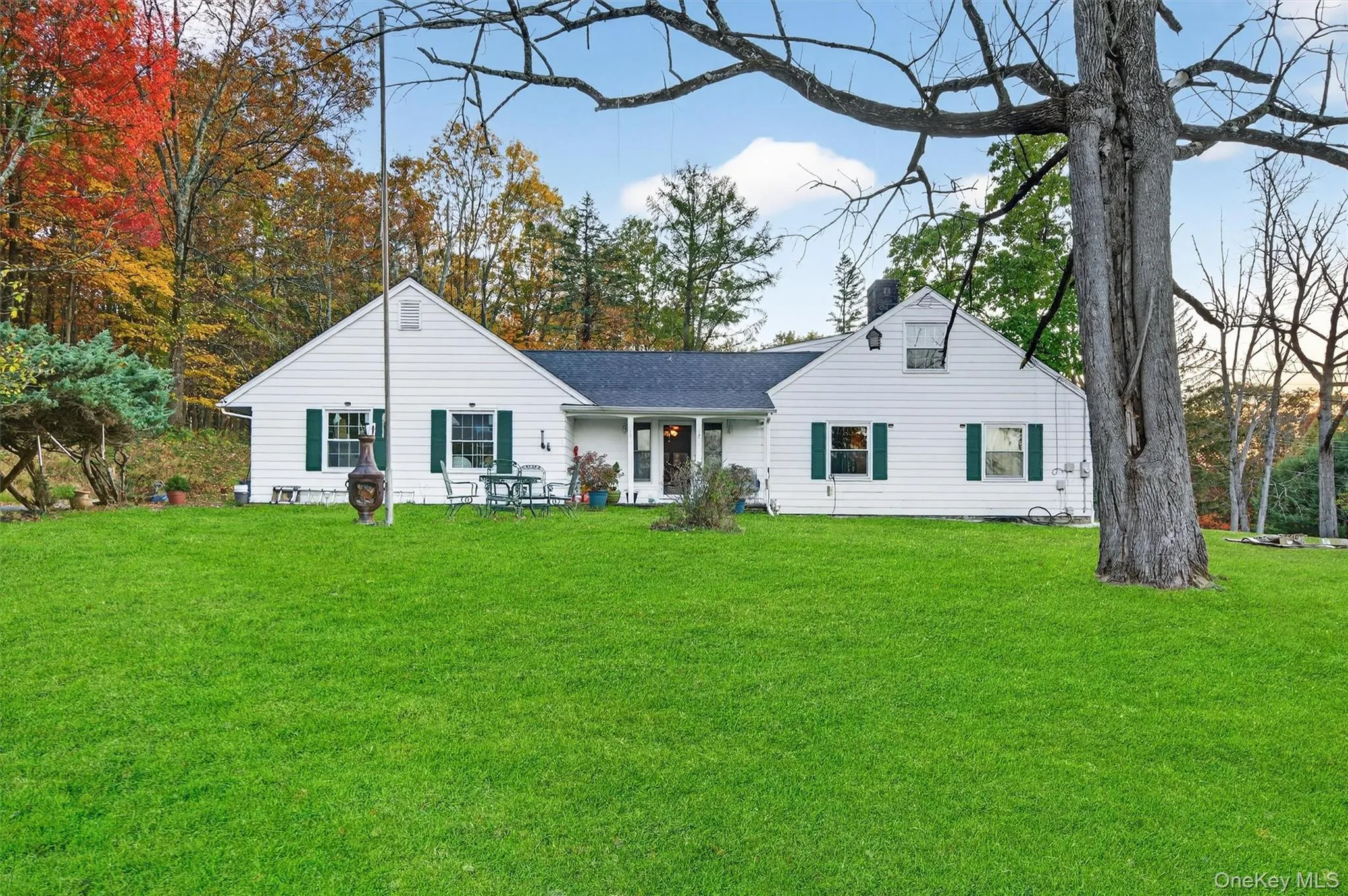 View of front of house featuring a front lawn, a chimney, and a porch View of front of house featuring a front lawn, a chimney, and a porch