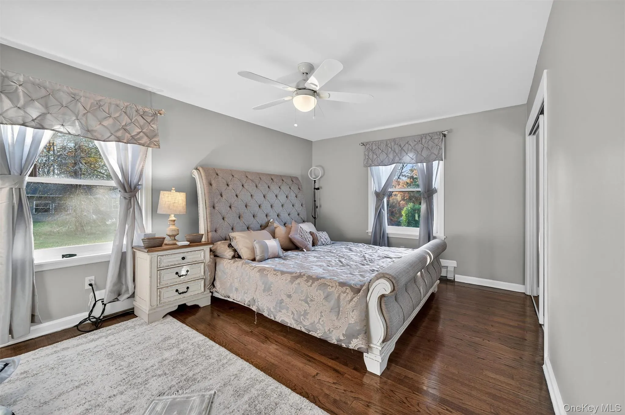 Bedroom with dark wood finished floors and ceiling fan Bedroom with dark wood finished floors and ceiling fan
