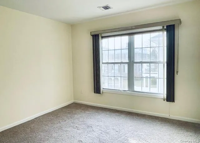 Unfurnished room featuring baseboards and carpet Unfurnished room featuring baseboards and carpet