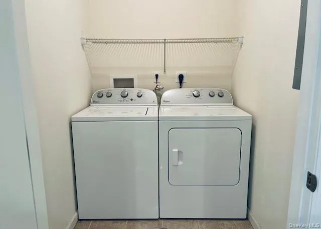 Laundry area featuring independent washer and dryer and baseboards Laundry area featuring independent washer and dryer and baseboards