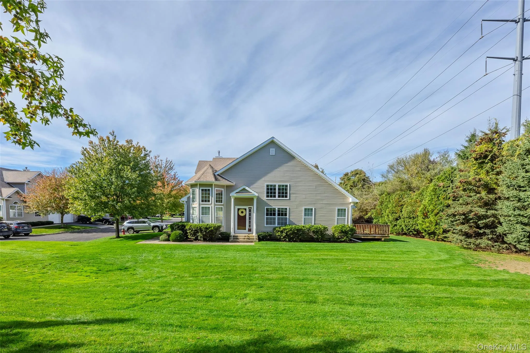 View of front of property with a front yard and a deck View of front of property with a front yard and a deck