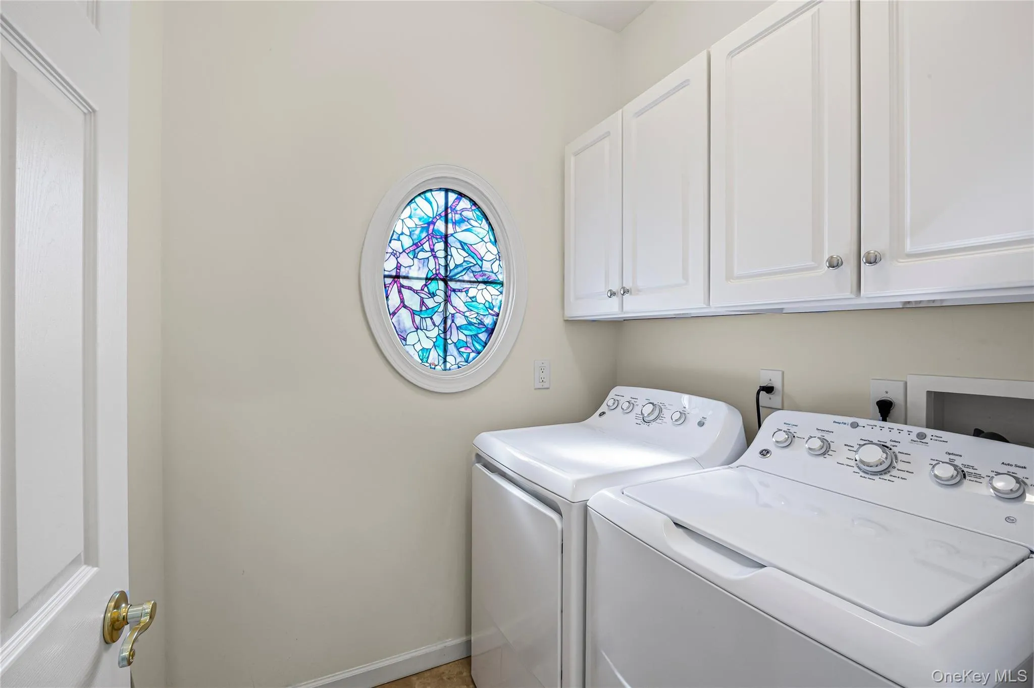 Washroom with cabinet space and washing machine and dryer Washroom with cabinet space and washing machine and dryer