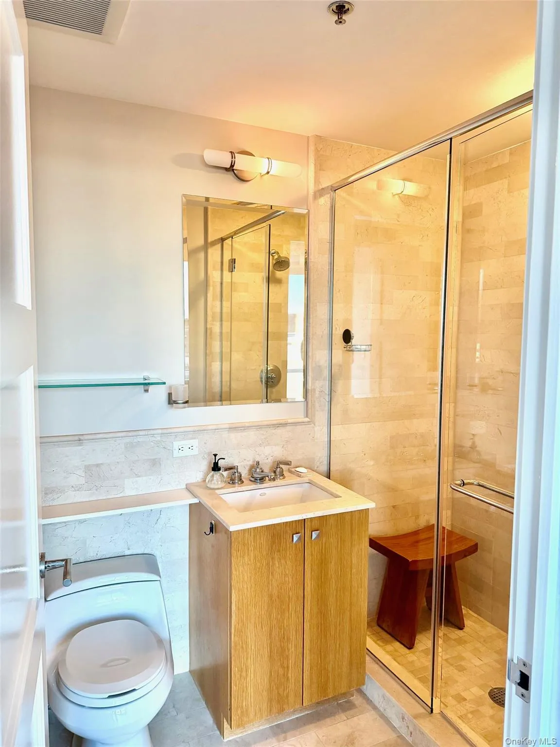 Bathroom with a shower stall, tile walls, and vanity Bathroom with a shower stall, tile walls, and vanity