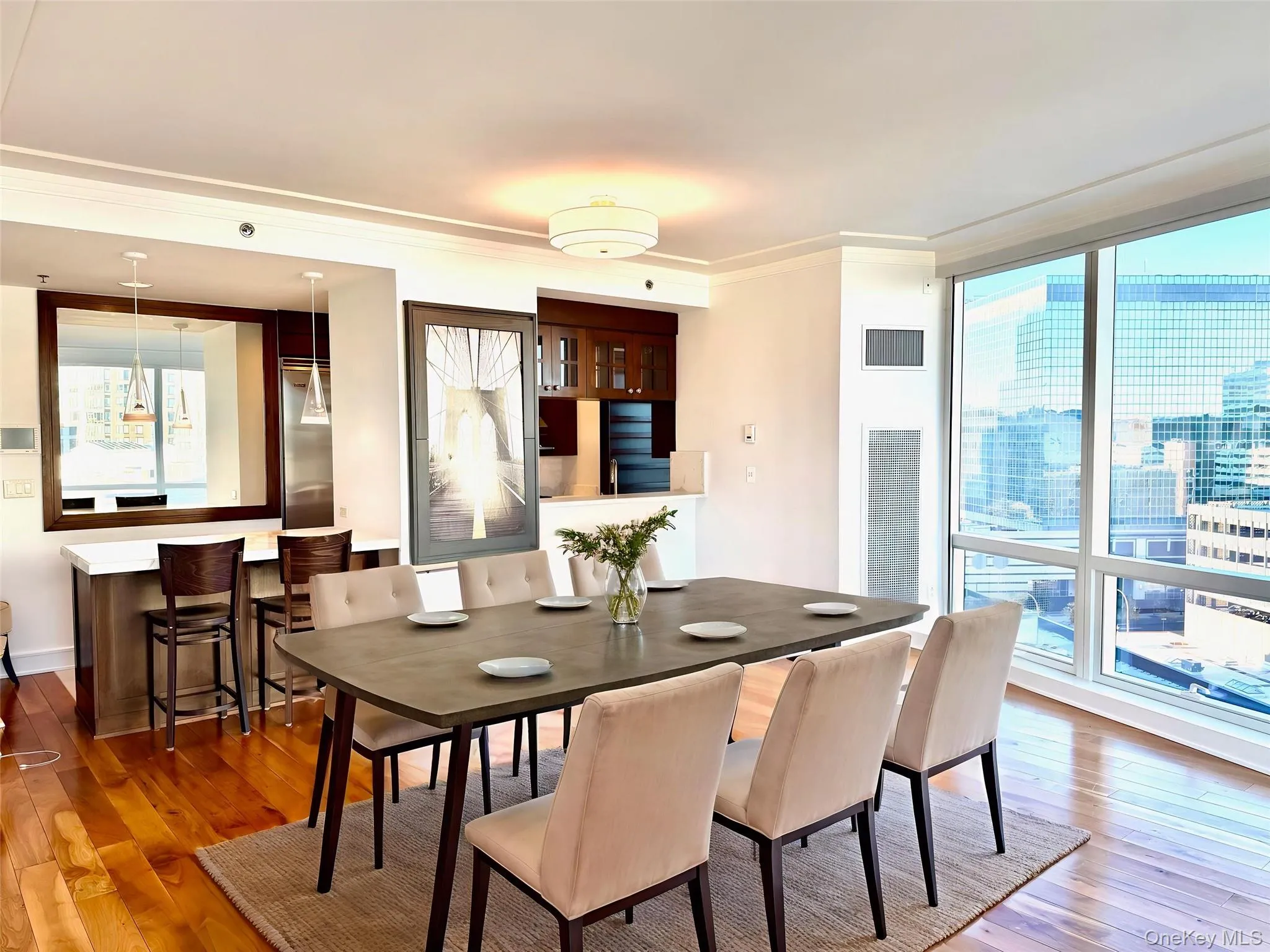 Dining area with wood-type flooring, crown molding, floor to ceiling windows, and a view of city Dining area with wood-type flooring, crown molding, floor to ceiling windows, and a view of city