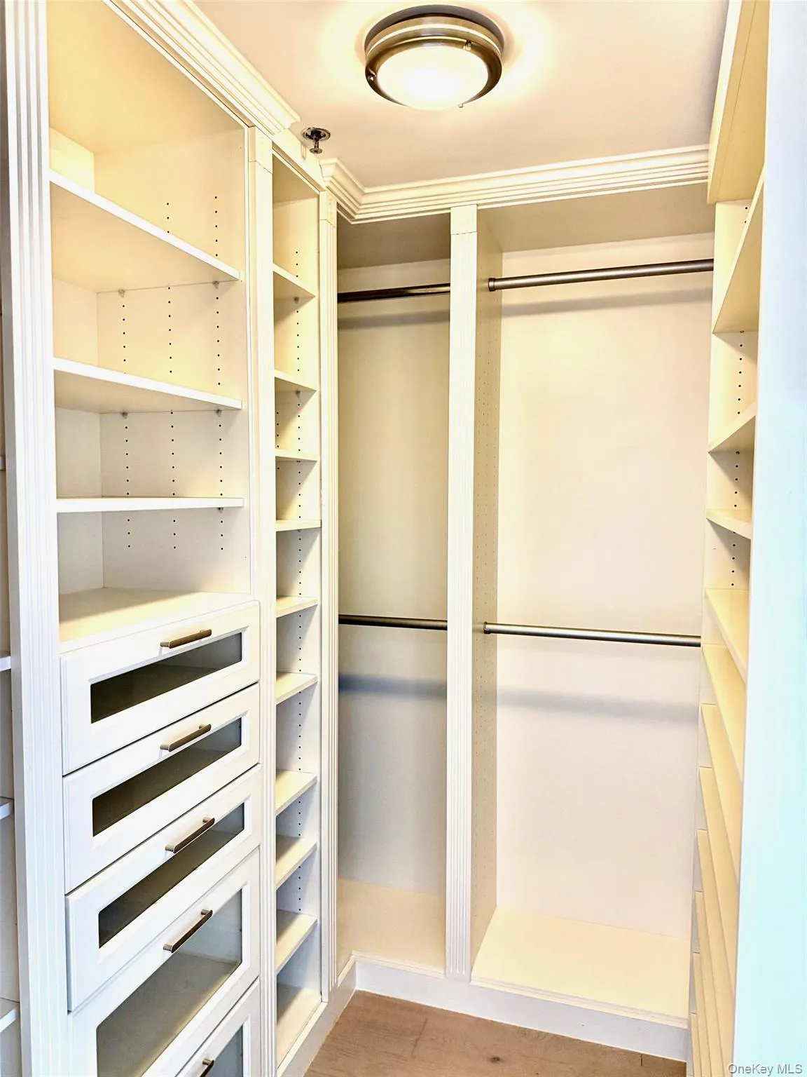 Walk in closet with light wood finished floors Walk in closet with light wood finished floors
