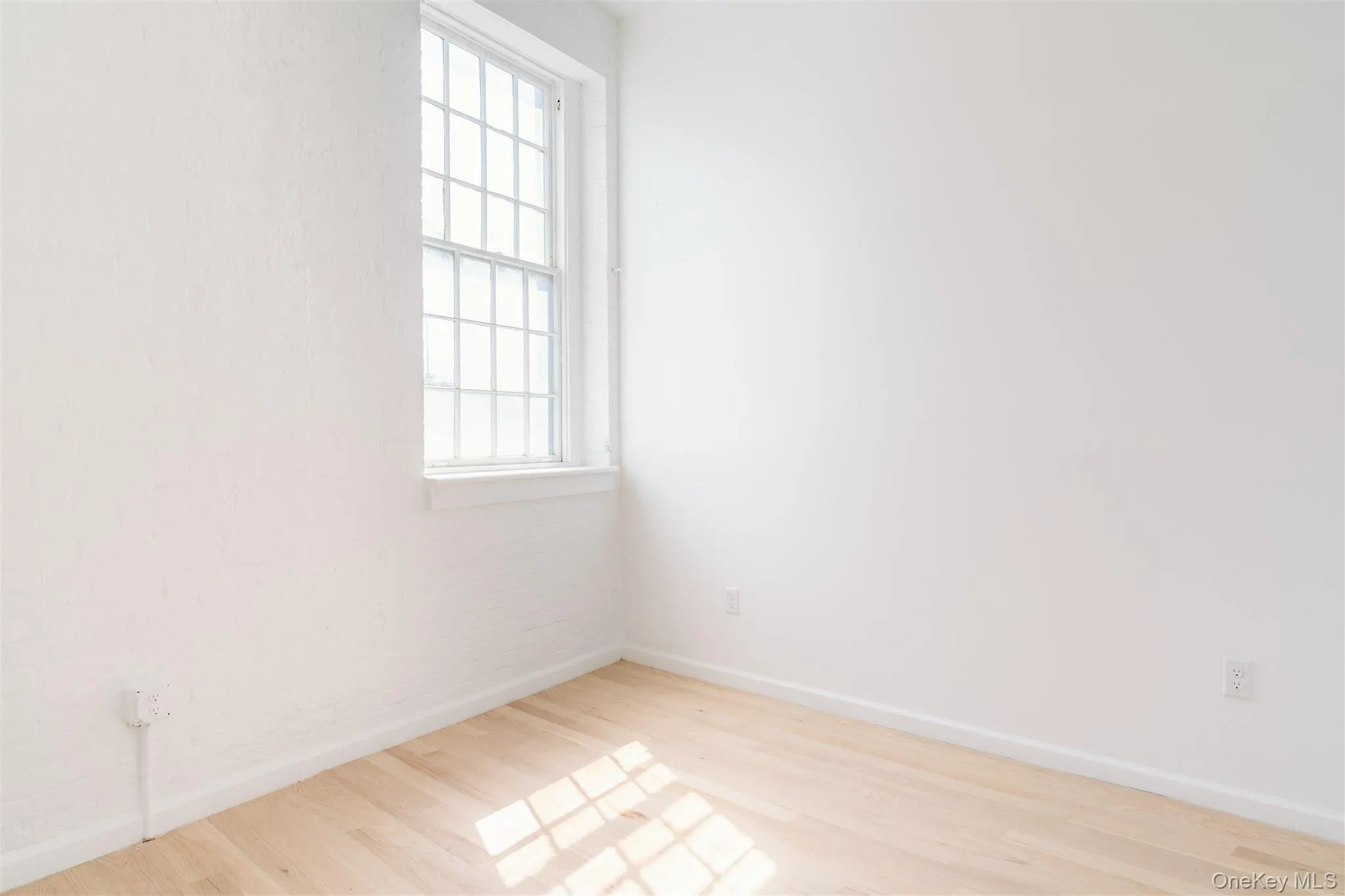 Empty room featuring baseboards and light wood-type flooring Empty room featuring baseboards and light wood-type flooring
