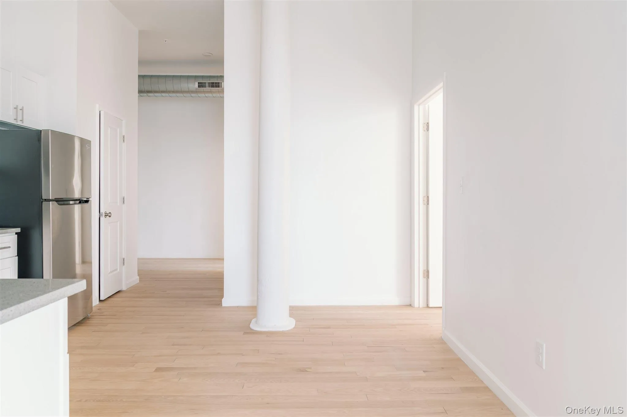 Hall featuring light wood finished floors Hall featuring light wood finished floors