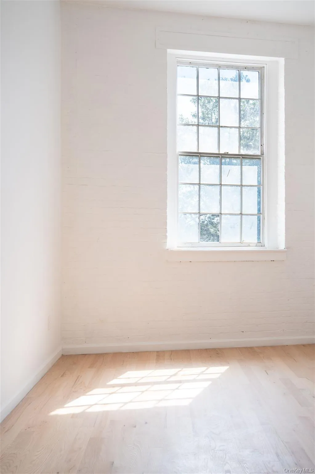 Empty room featuring baseboards and wood finished floors Empty room featuring baseboards and wood finished floors