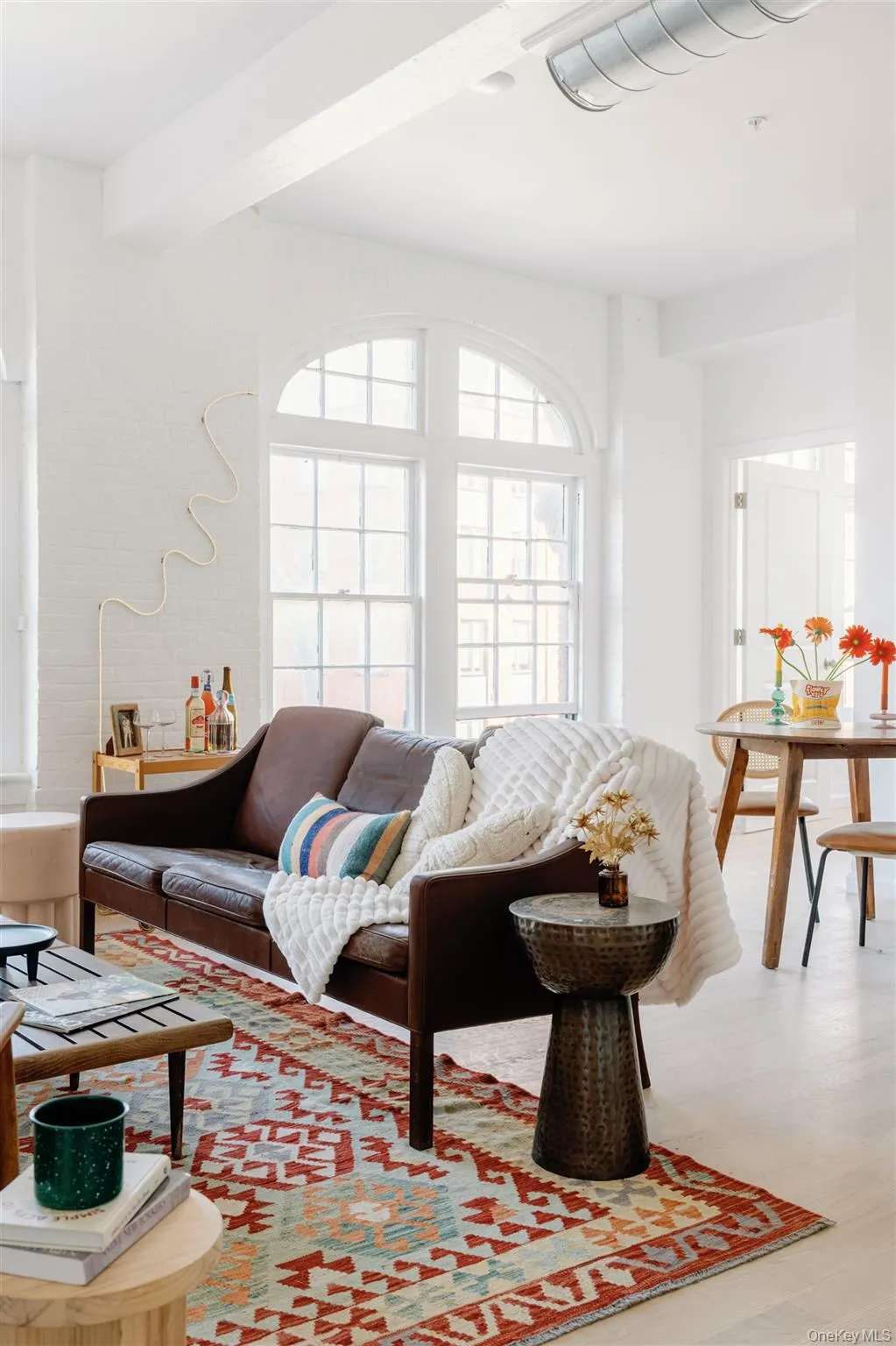Living area with beam ceiling and wood finished floors Living area with beam ceiling and wood finished floors