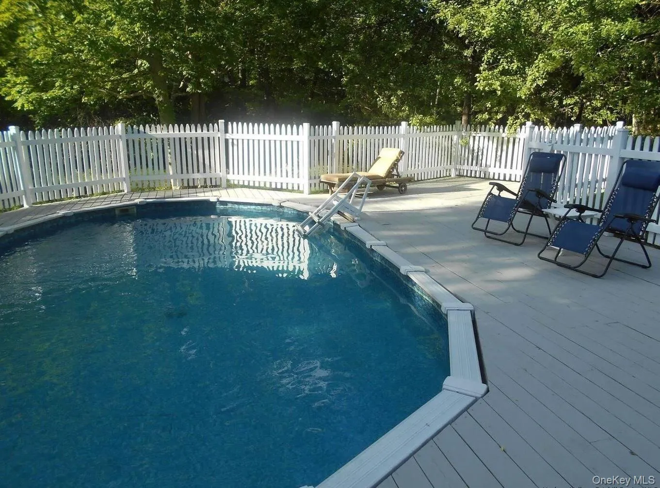 View of swimming pool with a wooden deck View of swimming pool with a wooden deck