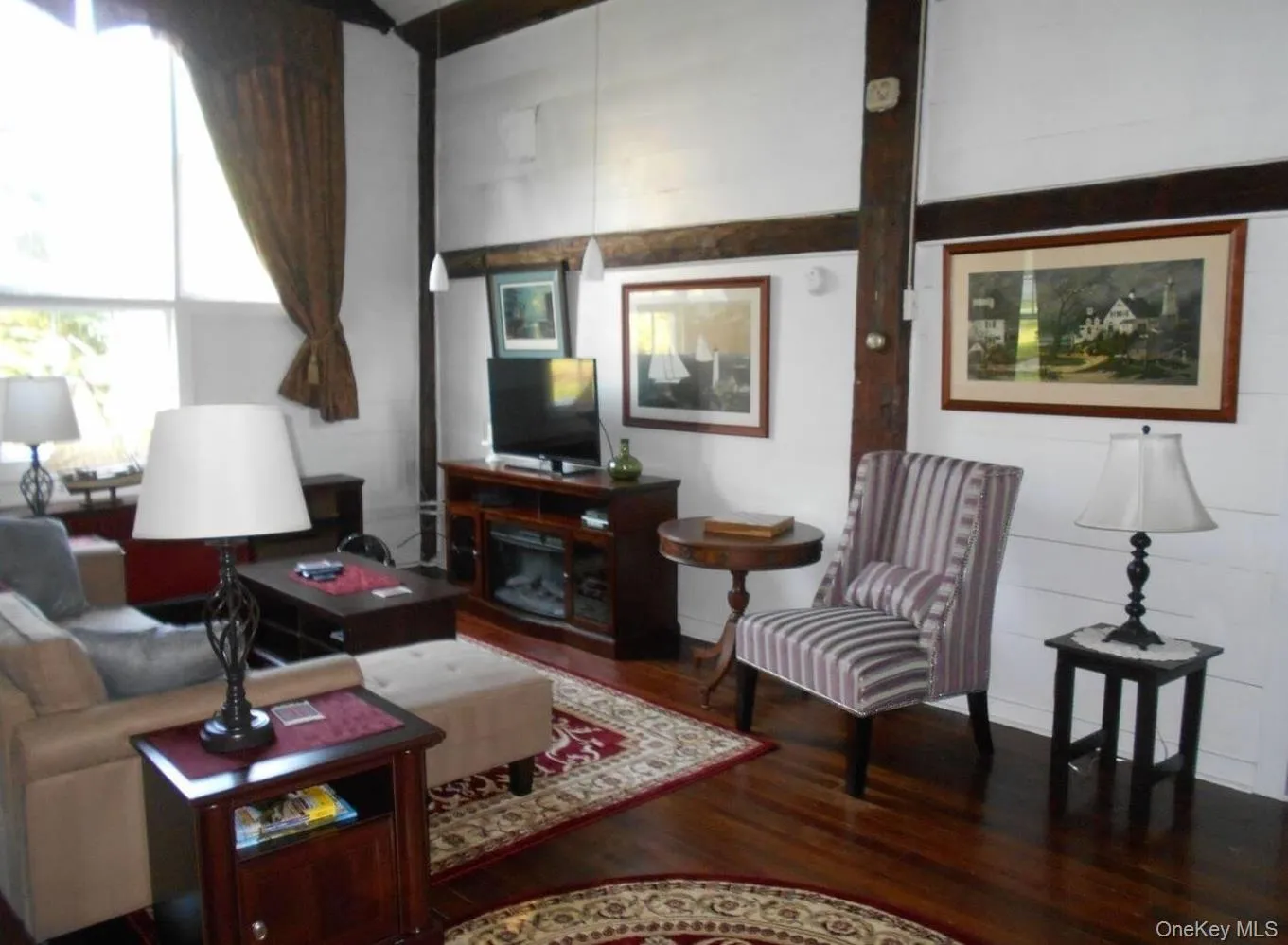 Living room featuring dark wood-style floors Living room featuring dark wood-style floors