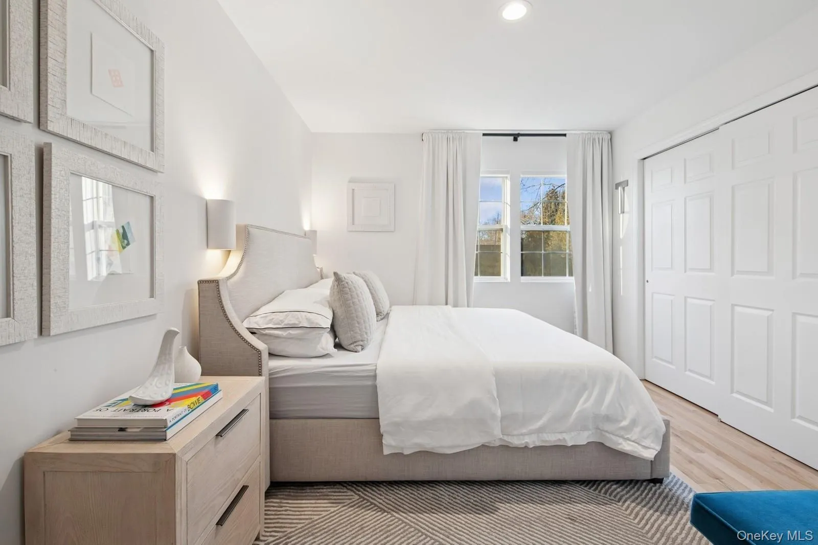 Bedroom featuring light wood finished floors, recessed lighting, and a closet Bedroom featuring light wood finished floors, recessed lighting, and a closet