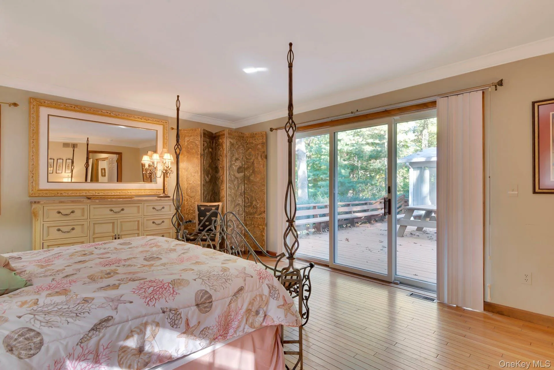 Bedroom with crown molding, light wood-type flooring, access to outside, and a chandelier Bedroom with crown molding, light wood-type flooring, access to outside, and a chandelier