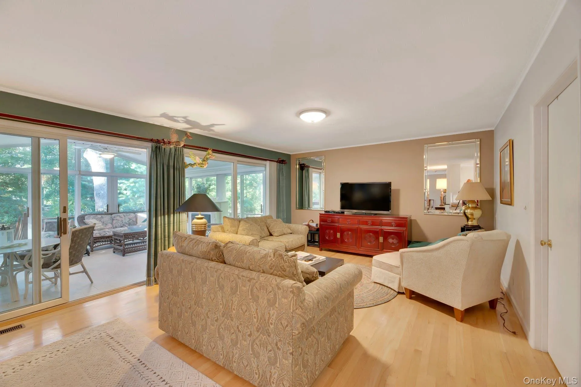 Living room with light wood finished floors and crown molding Living room with light wood finished floors and crown molding