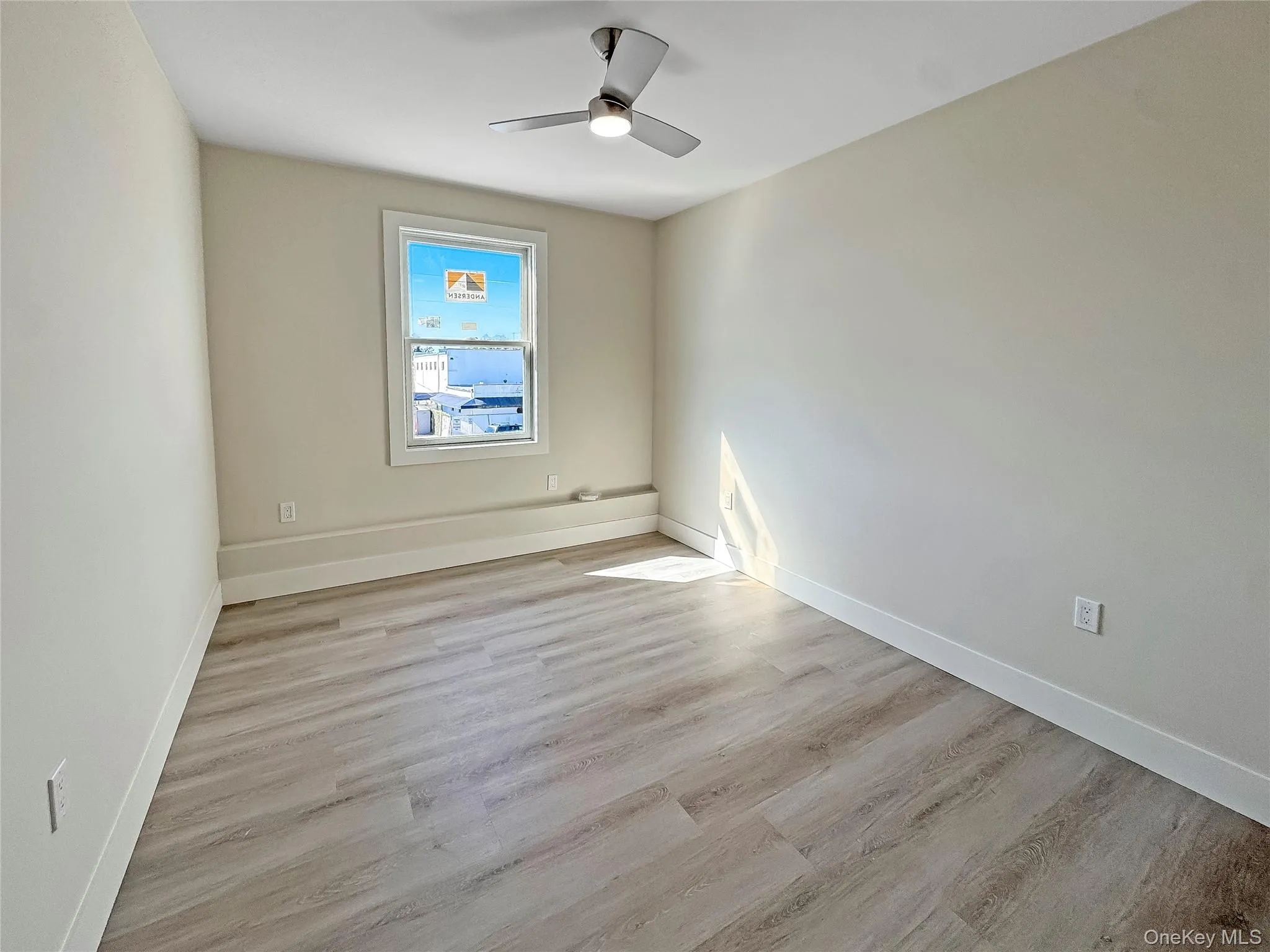 Unfurnished room featuring light wood-style floors and ceiling fan Unfurnished room featuring light wood-style floors and ceiling fan