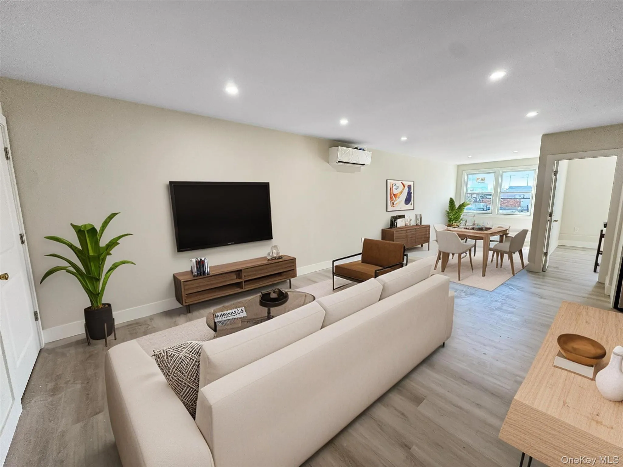 Living room with recessed lighting and light wood-type flooring Living room with recessed lighting and light wood-type flooring