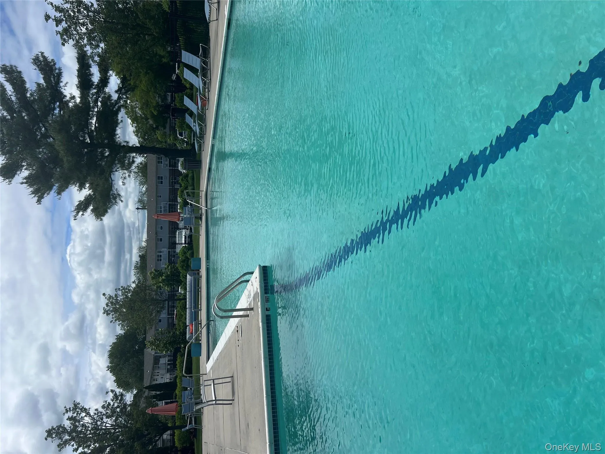 Community pool with a patio Community pool with a patio