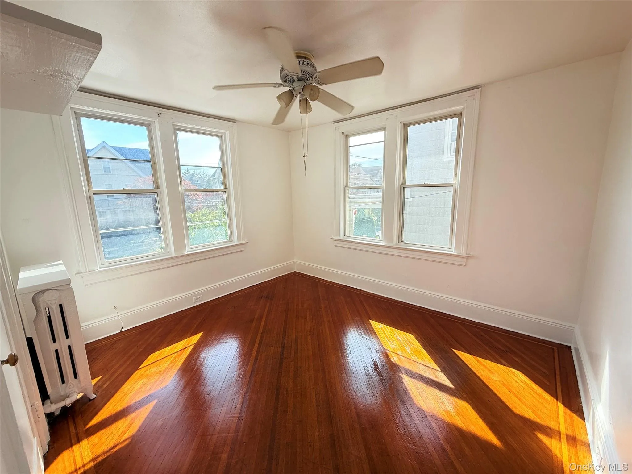 Bedroom featuring hardwood floors, a ceiling fan, and a closet, plenty of natural light. Bedroom featuring hardwood floors, a ceiling fan, and a closet, plenty of natural light.