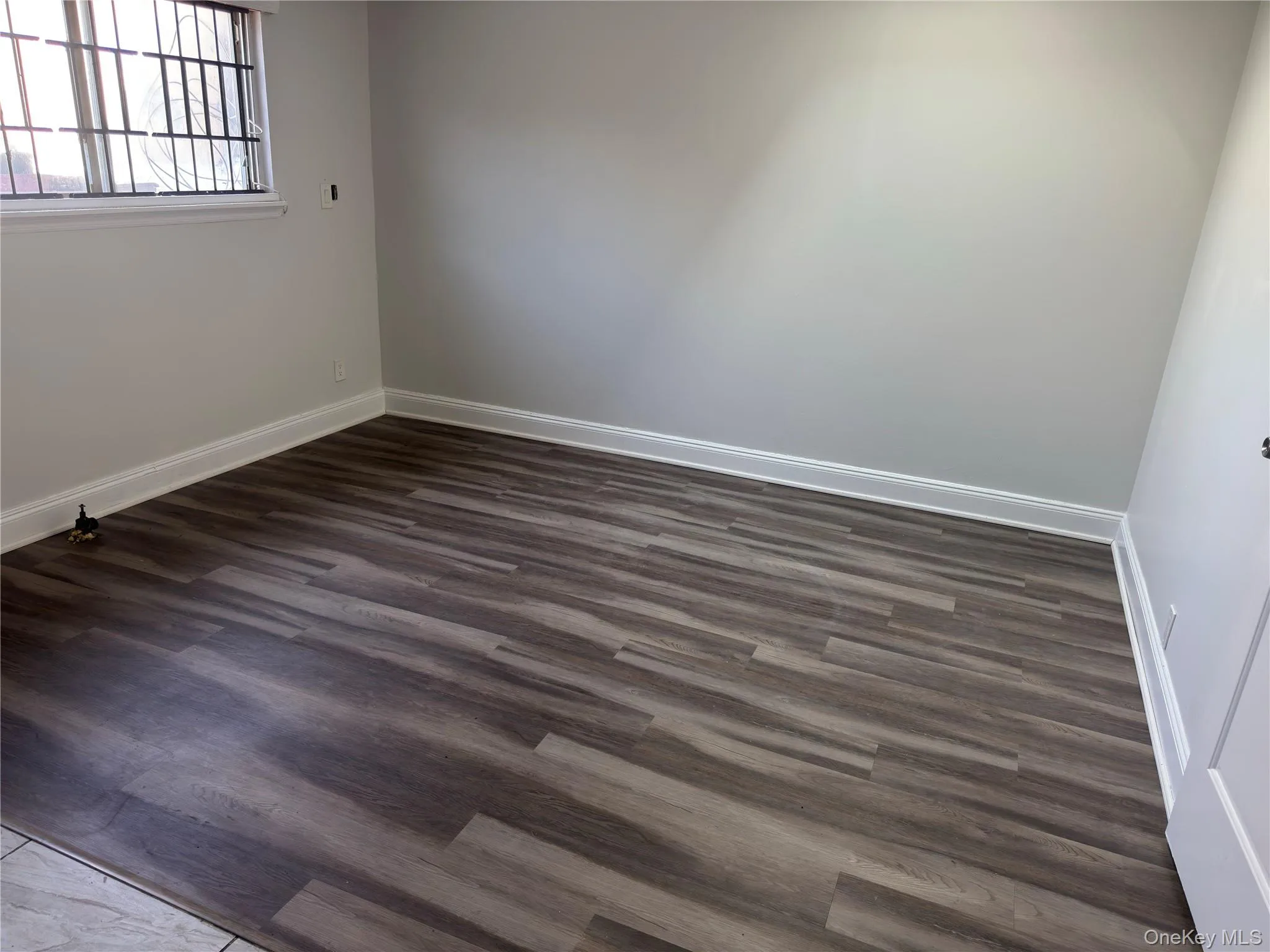 Spare room featuring dark wood finished floors Spare room featuring dark wood finished floors