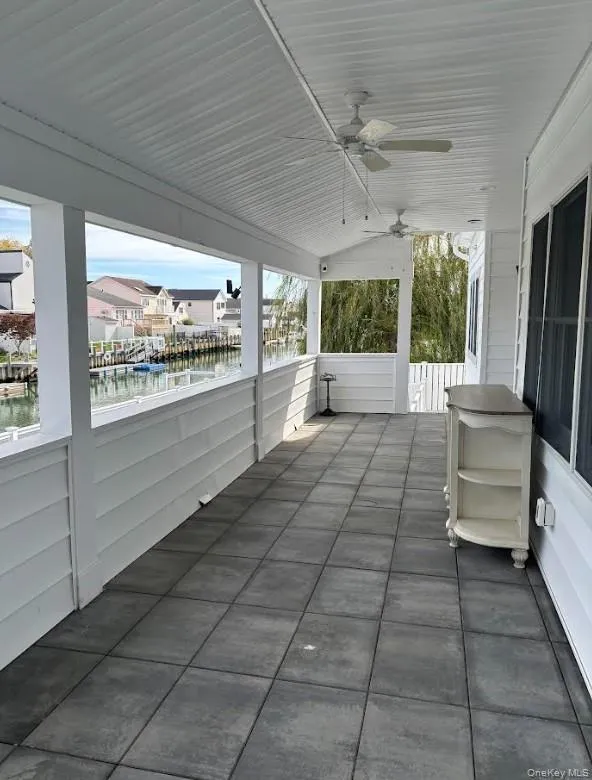 View of patio / terrace with ceiling fan, a water view, and a residential view View of patio / terrace with ceiling fan, a water view, and a residential view