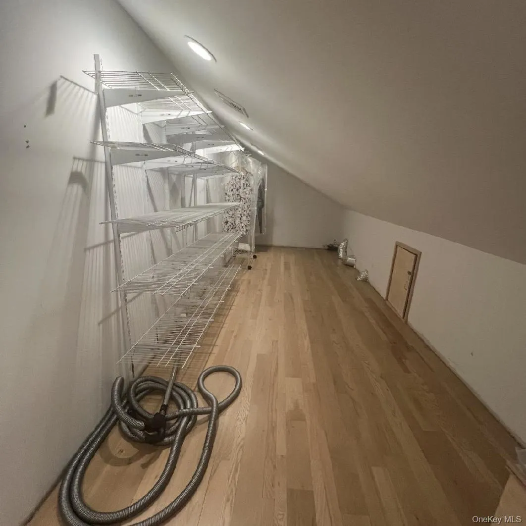 Additional living space with light wood-style flooring and vaulted ceiling Additional living space with light wood-style flooring and vaulted ceiling