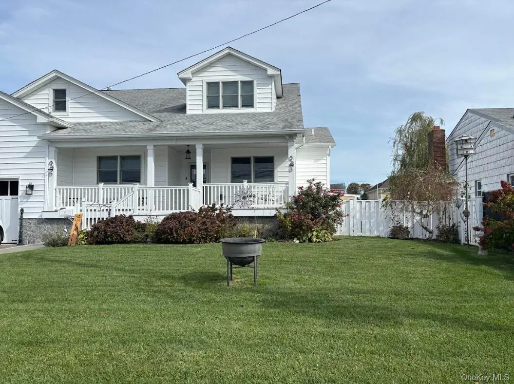 View of front of home with a shingled roof and covered porch View of front of home with a shingled roof and covered porch