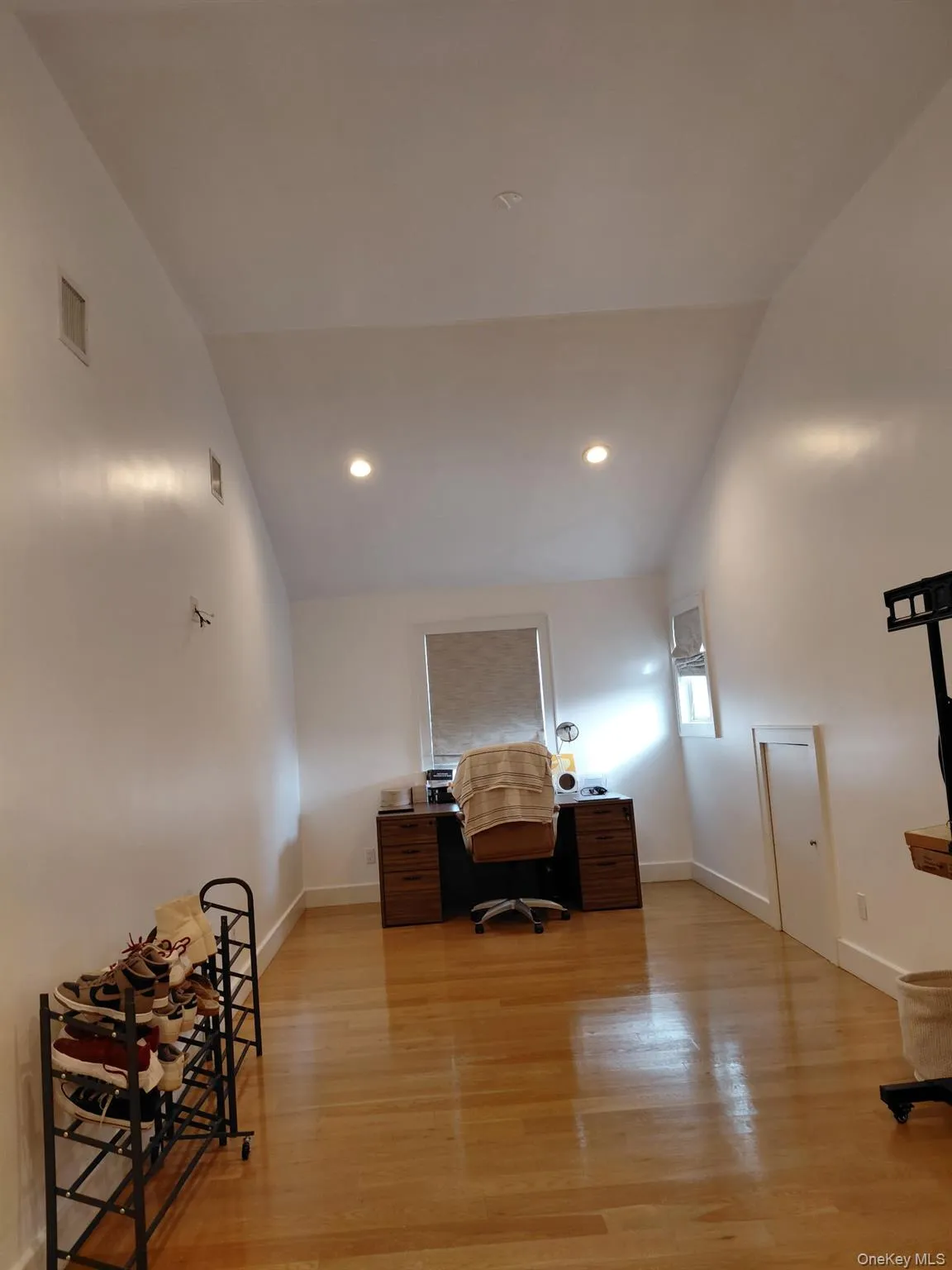 Home office with light wood finished floors, high vaulted ceiling, and recessed lighting Home office with light wood finished floors, high vaulted ceiling, and recessed lighting