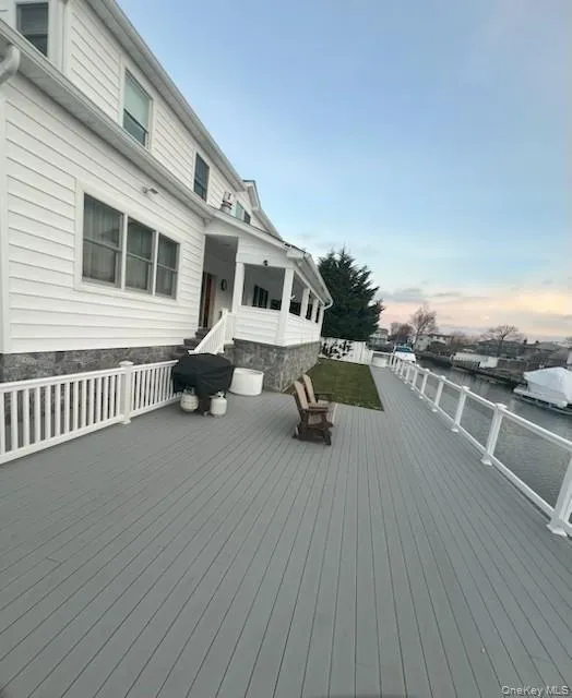 Deck at dusk featuring a water view Deck at dusk featuring a water view