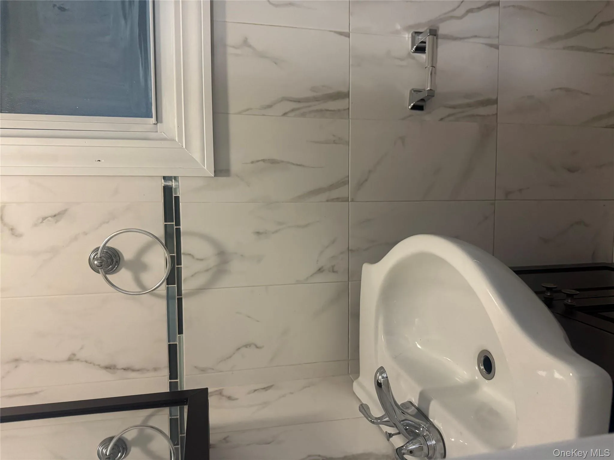 Bathroom featuring vanity and tile walls Bathroom featuring vanity and tile walls