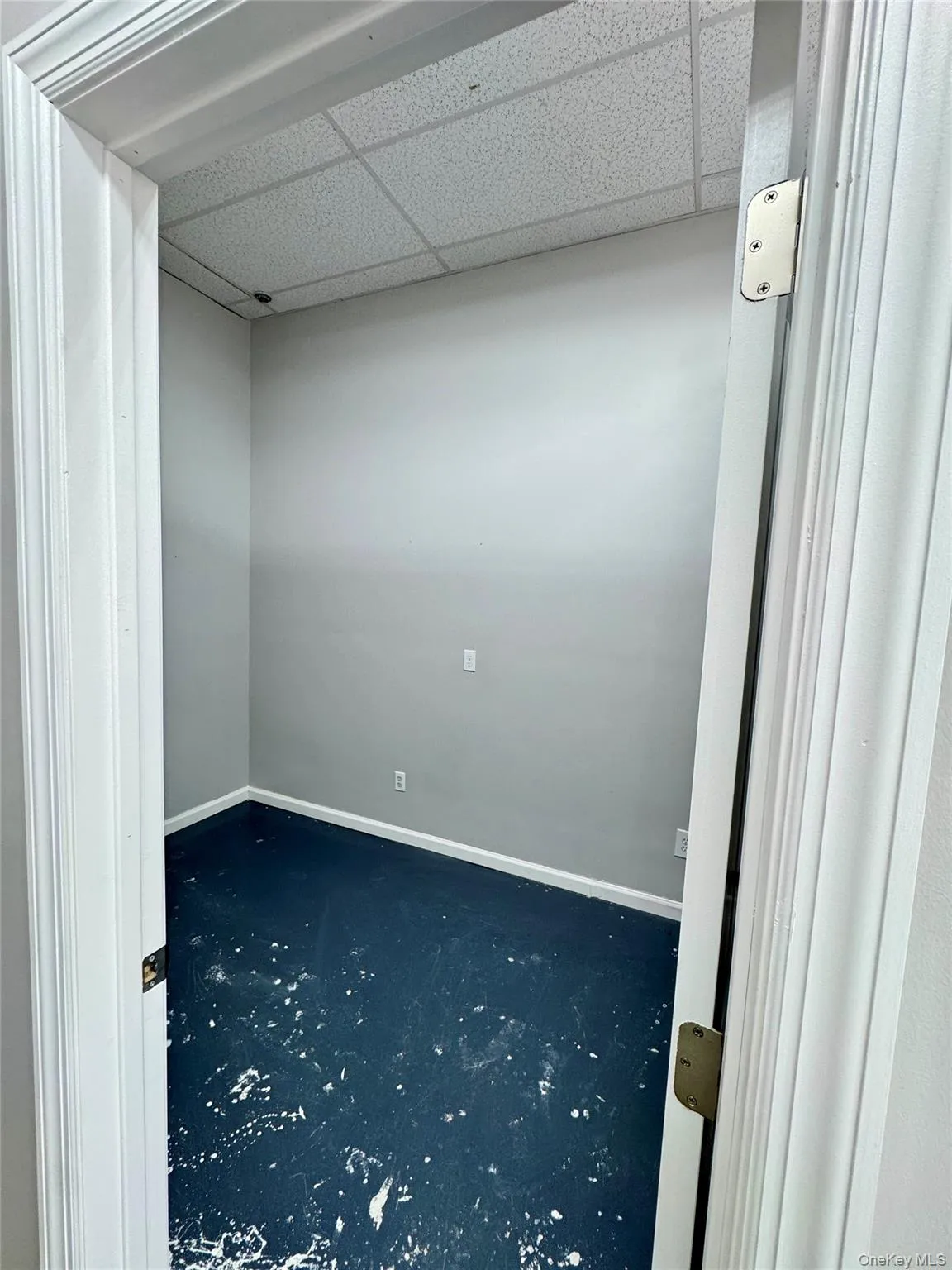 Spare room featuring baseboards and a drop ceiling Spare room featuring baseboards and a drop ceiling