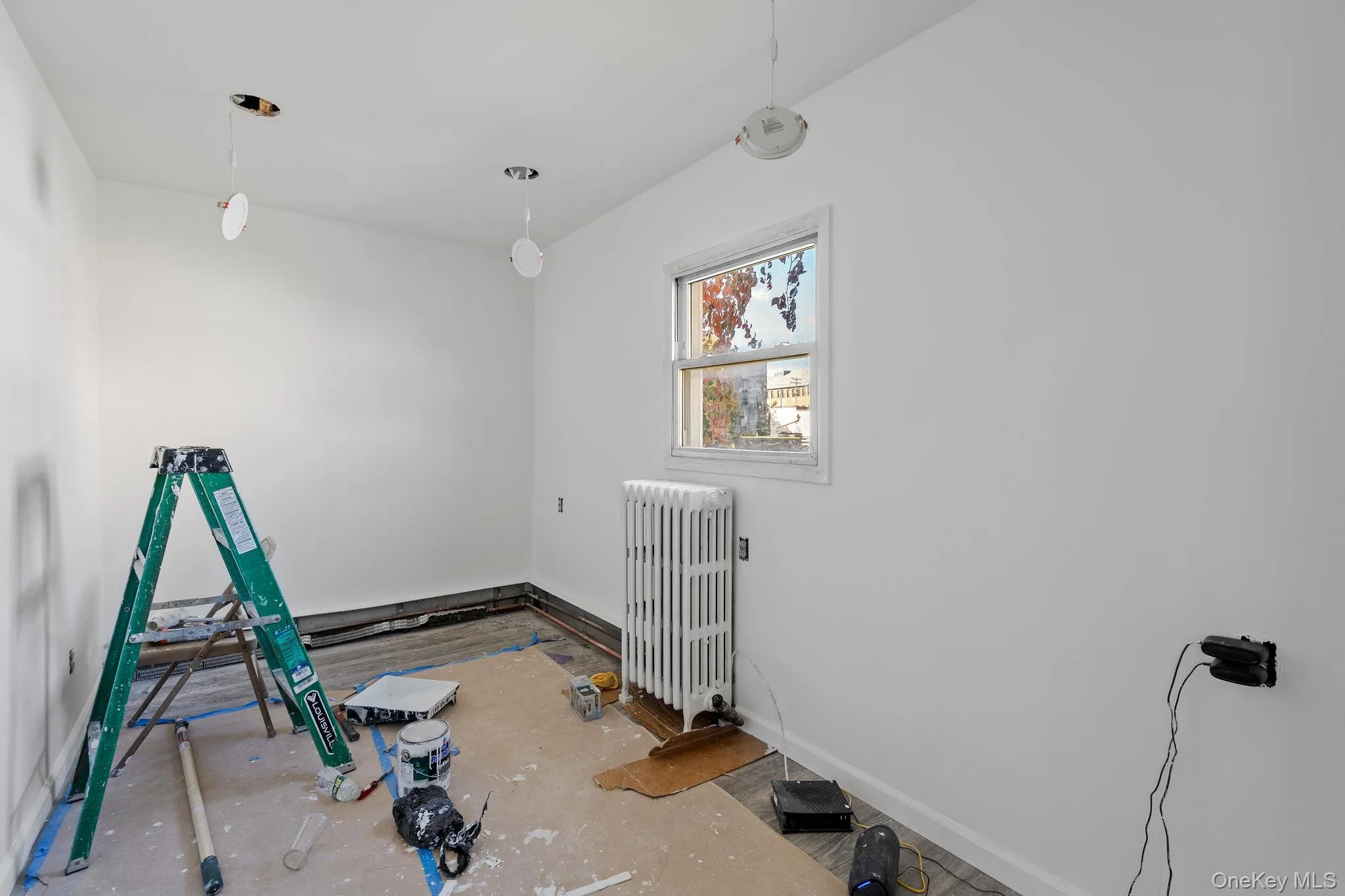 Spare room with radiator heating unit and baseboards Spare room with radiator heating unit and baseboards