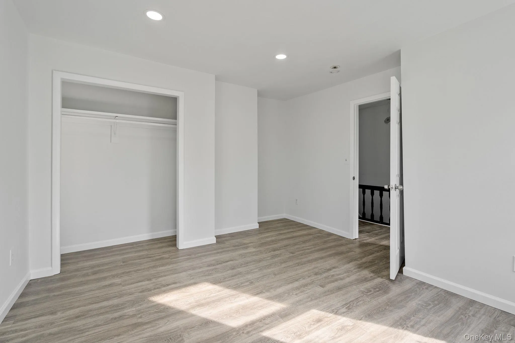 Unfurnished bedroom featuring light wood-style floors, recessed lighting, and a closet Unfurnished bedroom featuring light wood-style floors, recessed lighting, and a closet